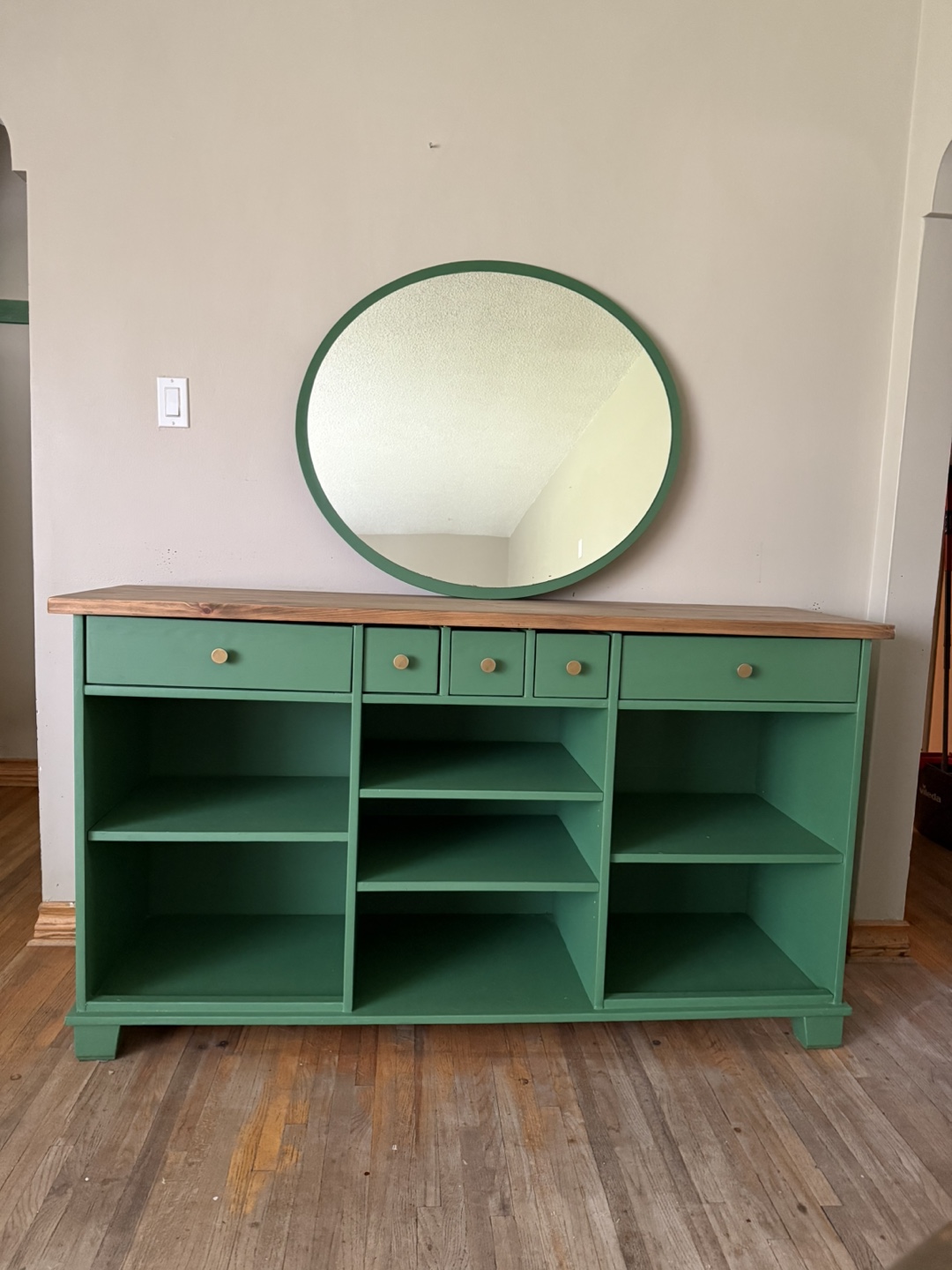 Custom-painted green console table with shelving and drawers