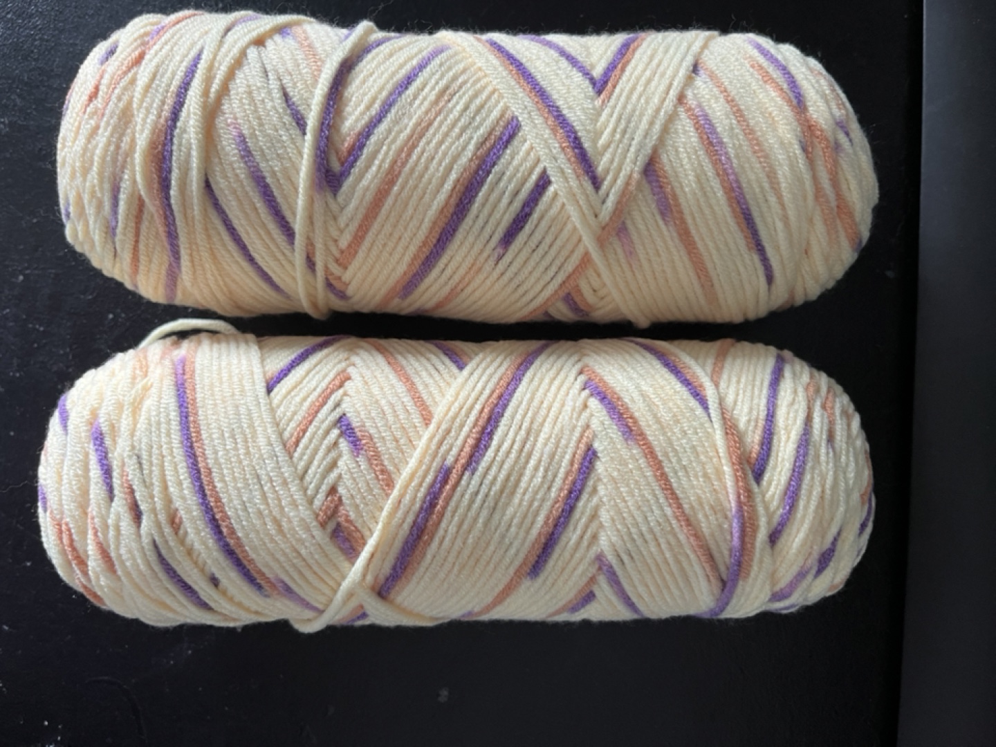 Two Skeins of Yarn - Cream, Purple, and Peach