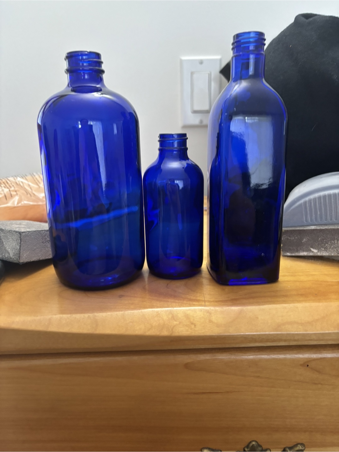 Three cobalt blue glass bottles