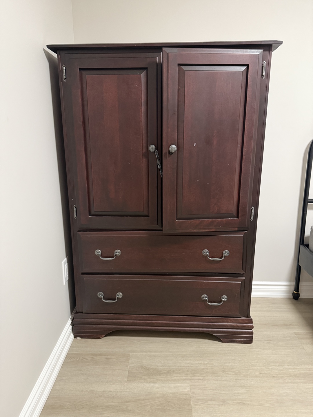 Dark brown wooden armoire with two drawers