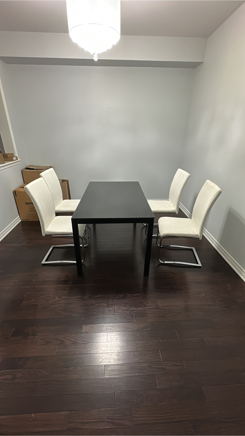 Modern Black Glass Dining Table with Four White Chairs