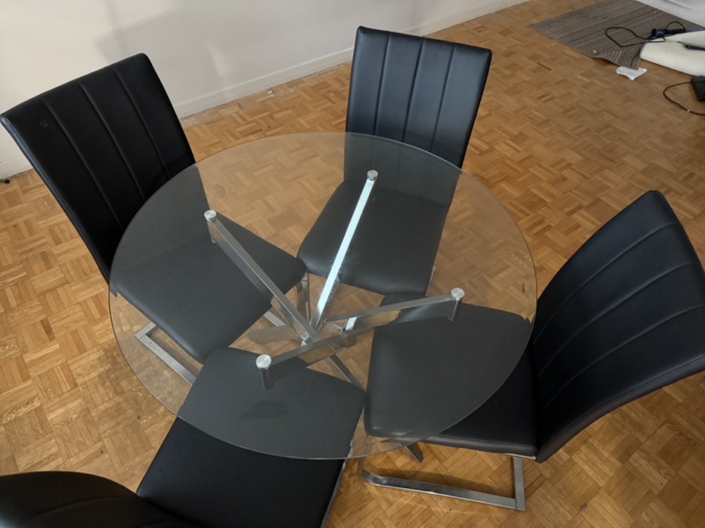 Glass Top Dining Table with Four Black Chairs