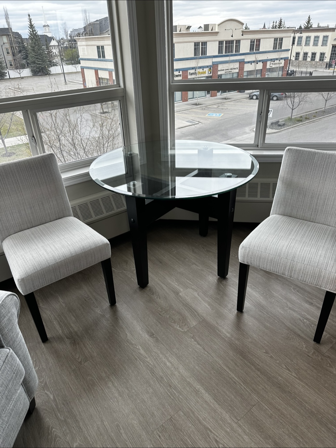 Glass-top dining table and two chairs