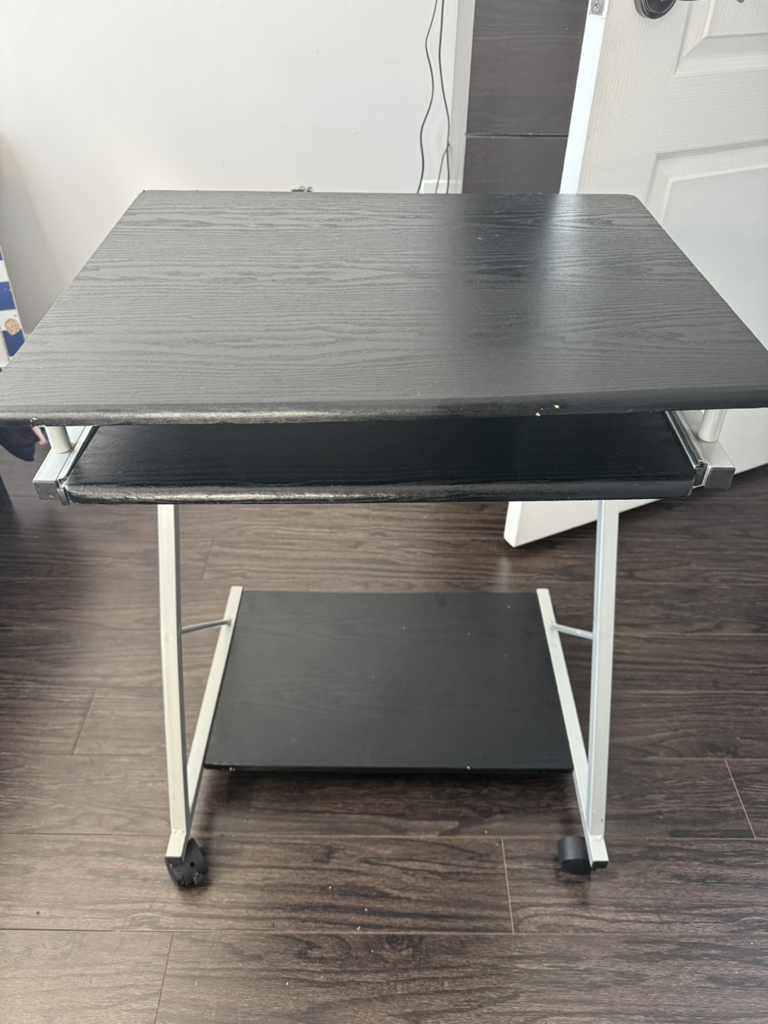 Small black computer desk with keyboard tray and wheels