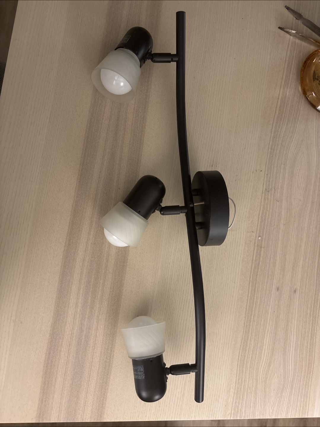 Three-light curved track lighting fixture