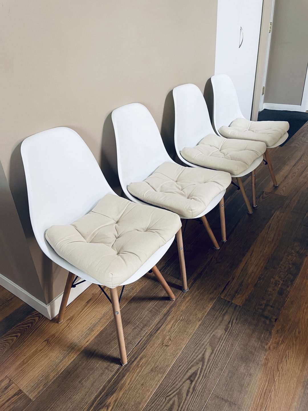 Set of Four White Plastic Dining Chairs with Wooden Legs