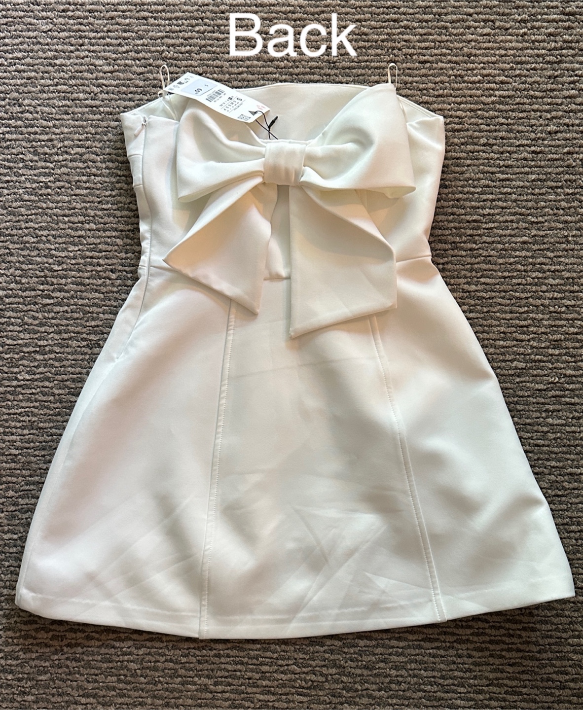 White strapless mini dress with large bow detail