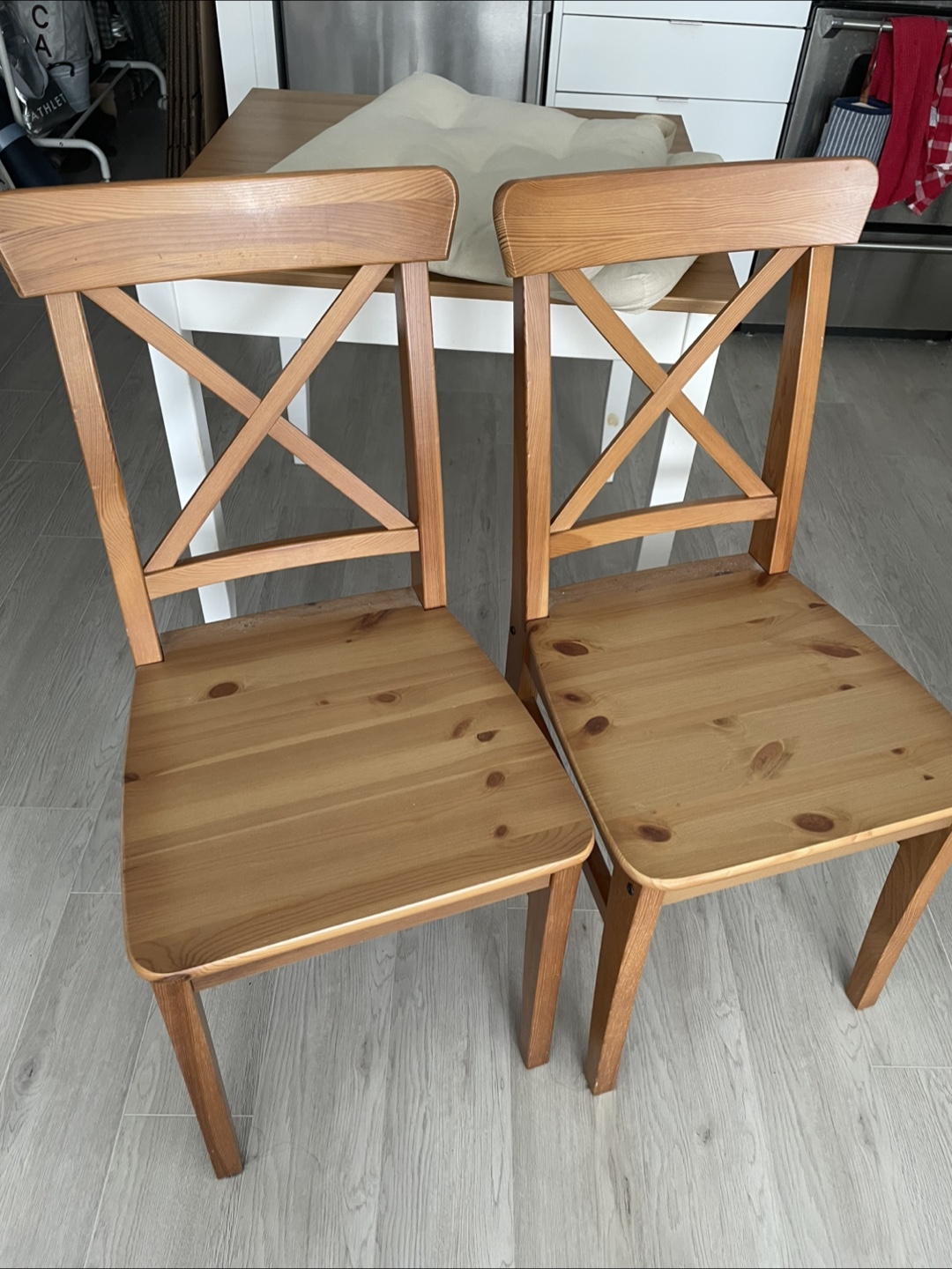 Two IKEA Ingolf wooden dining chairs