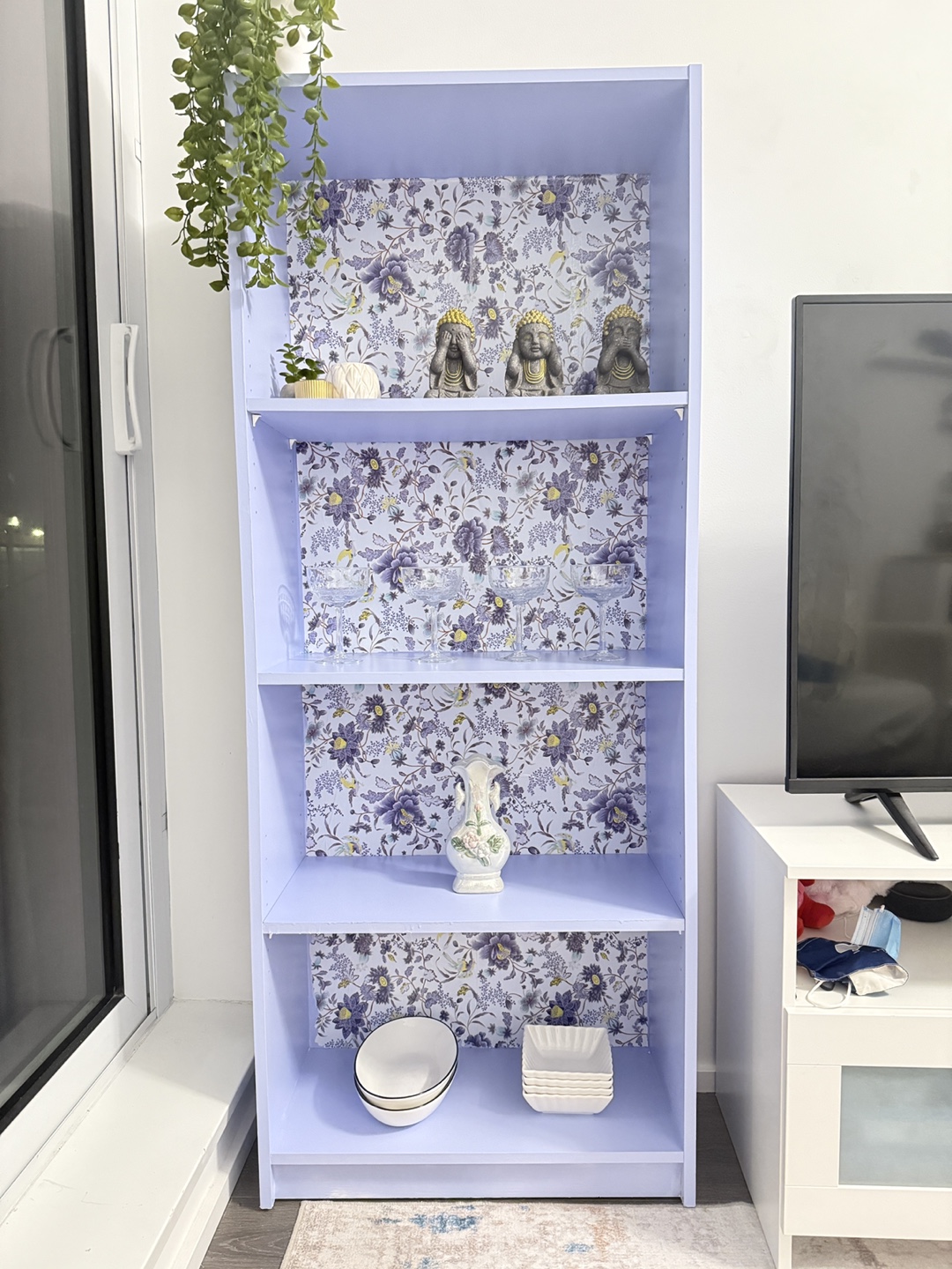 Lilac Bookcase with Floral Wallpaper Accent