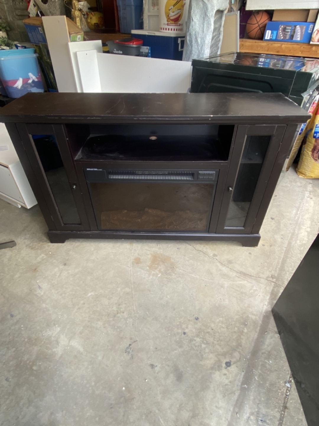 Dark brown entertainment center with electric fireplace