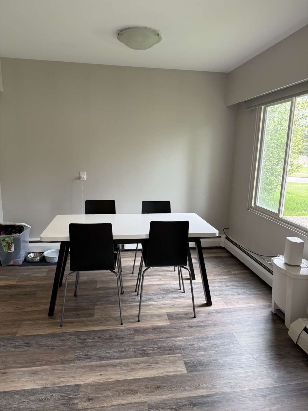 White Ikea Table and Four Black Chairs