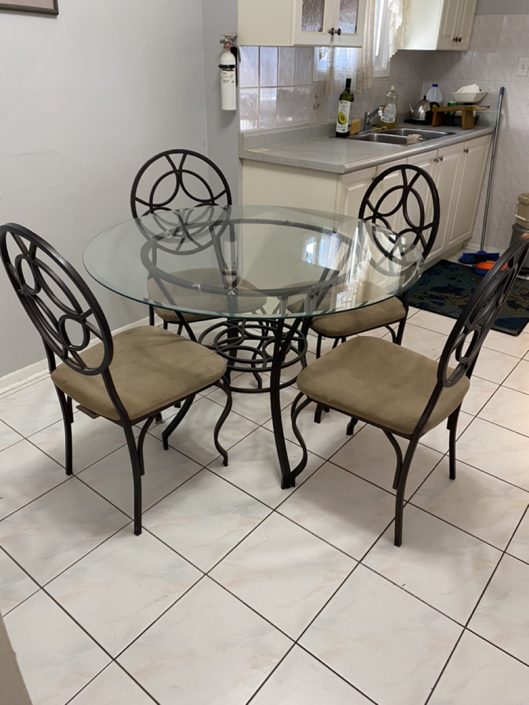 Glass-top dining table set with four chairs