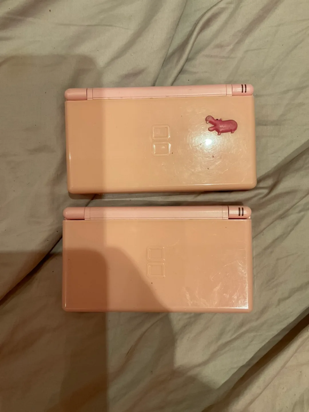 Two pink Nintendo DS Lites thumbnail