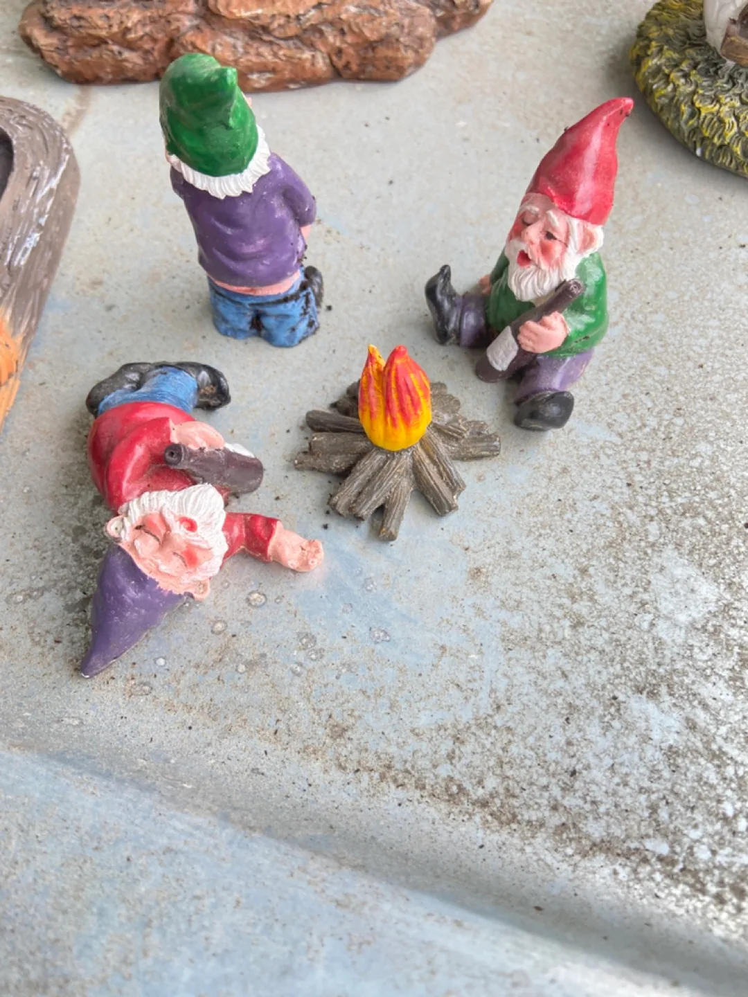 Set of three garden gnomes around a campfire thumbnail