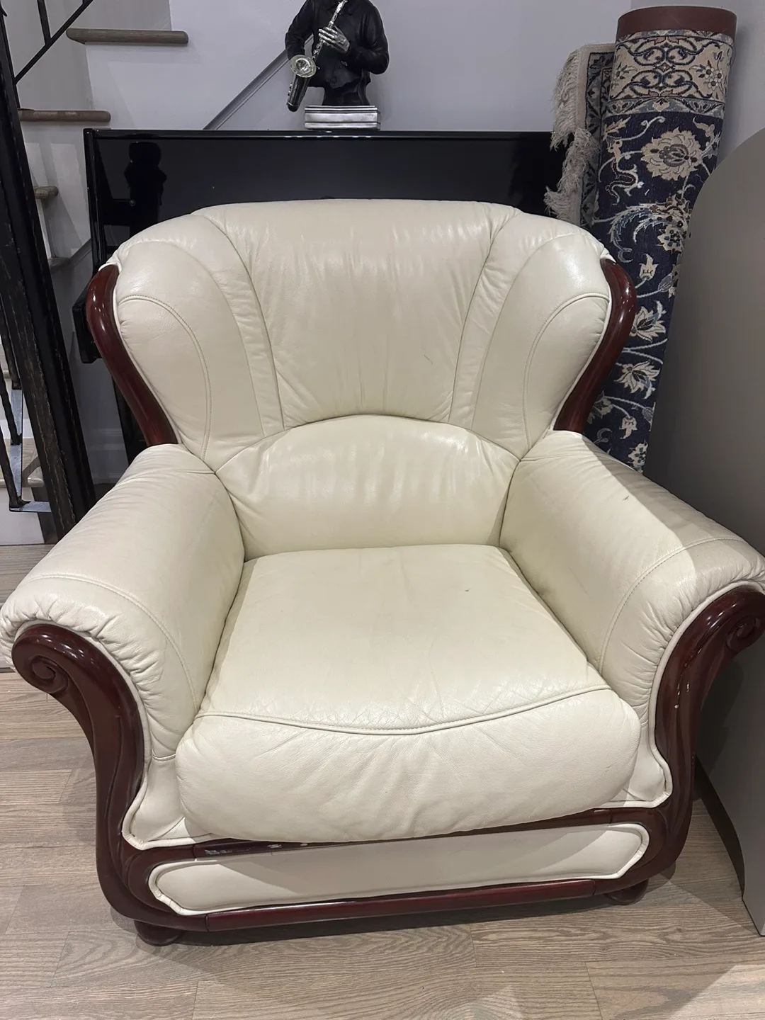 Cream coloured armchair with wooden accents thumbnail