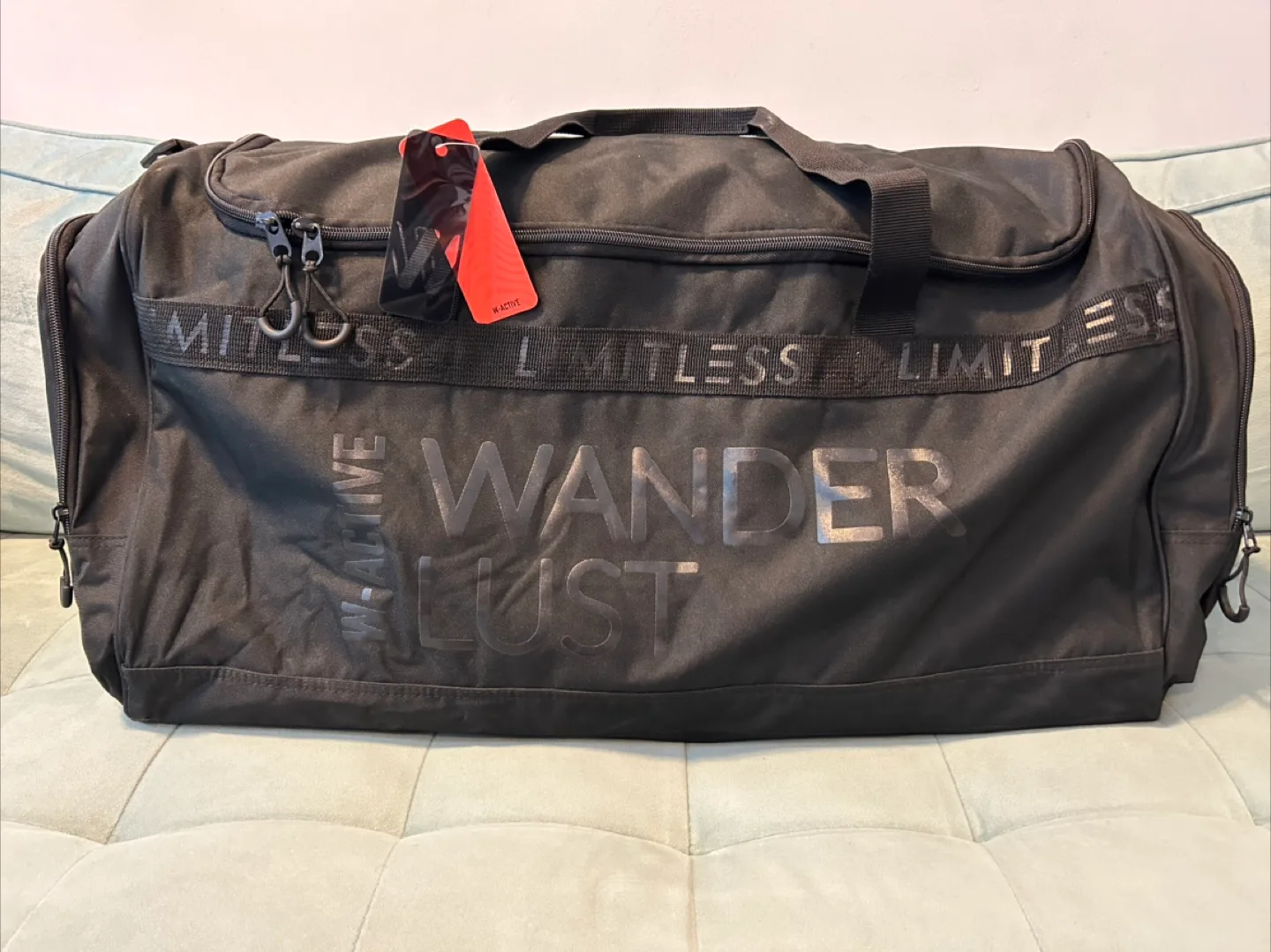 Black duffle bag - 'Wanderlust' text thumbnail