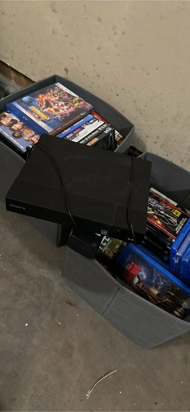 Used DVD Player and 2 boxes of discs thumbnail