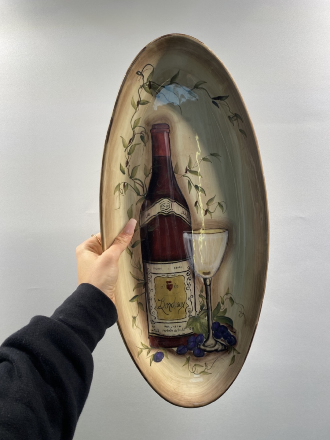 Oval serving platter with wine motif.