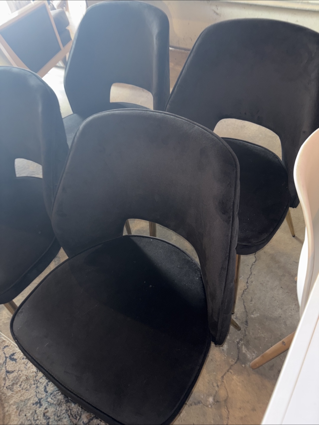 4 black chairs with gold legs