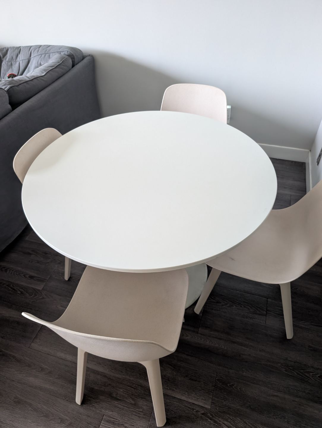 White Round Dining Table with Four Beige Chairs