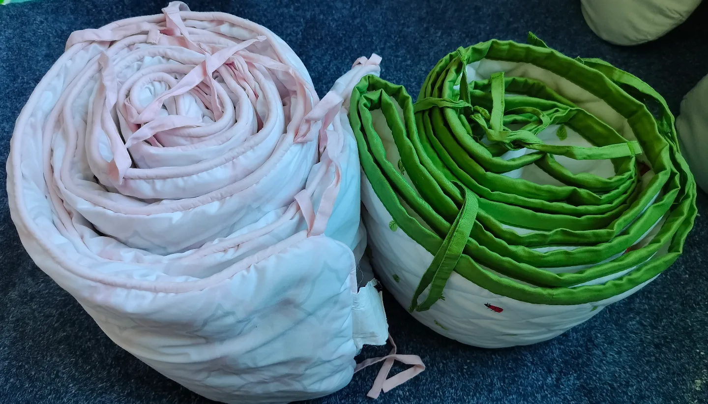 Two crib bumpers, pink and green image indicator(2)