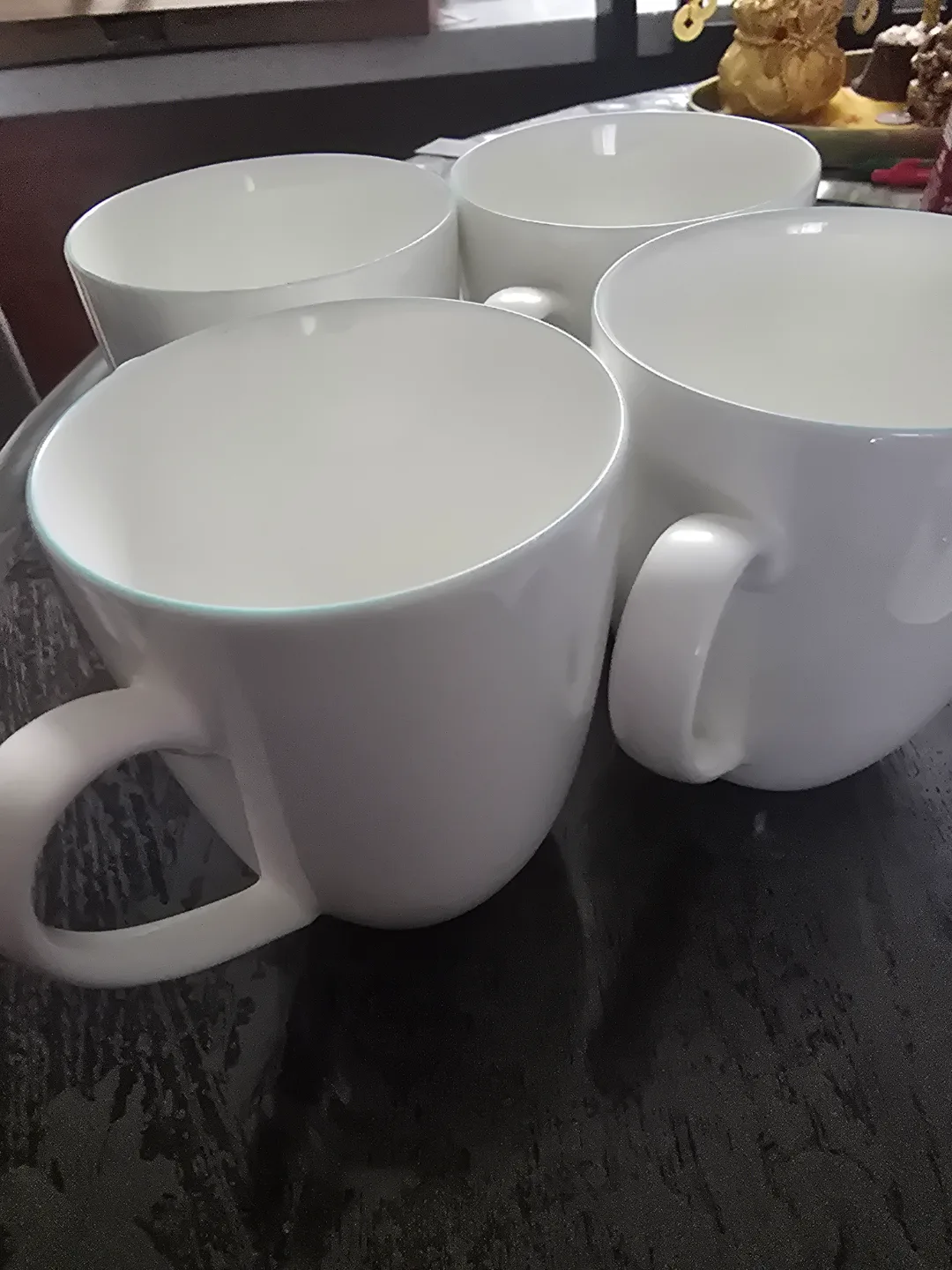 Set of four white porcelain mugs image indicator(2)