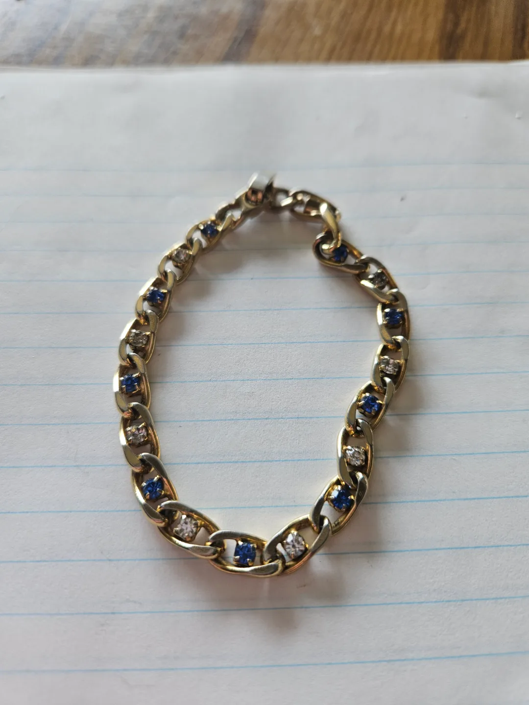 Gold tone bracelet with blue and clear stones thumbnail