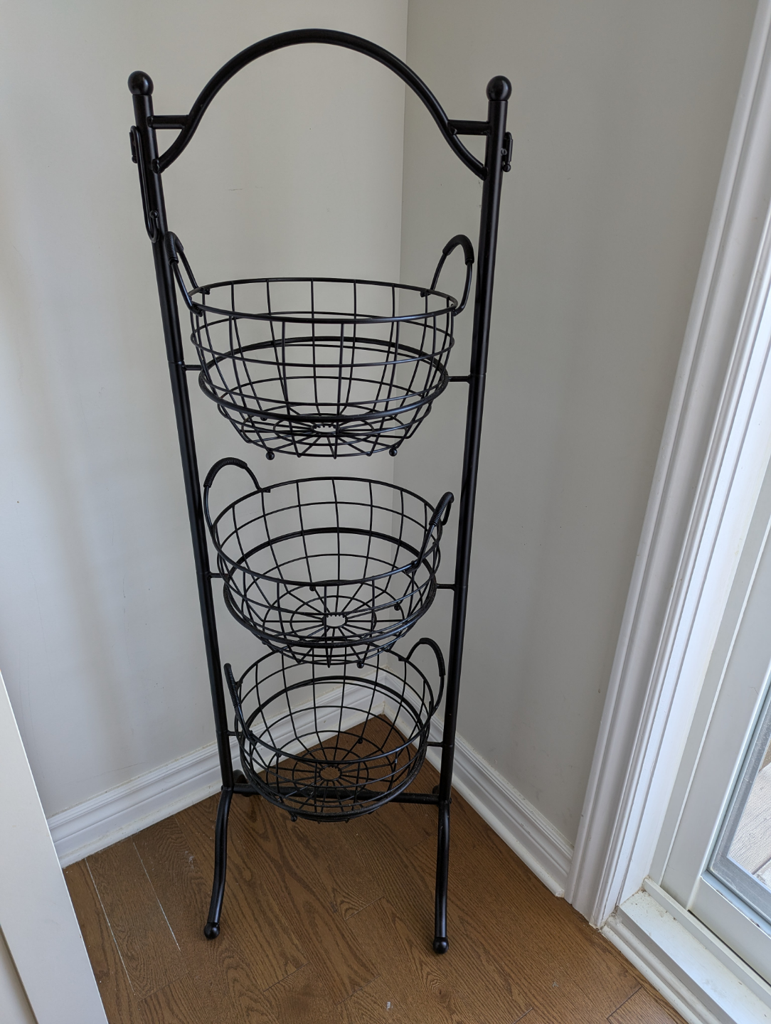 Three-tiered wire basket stand
