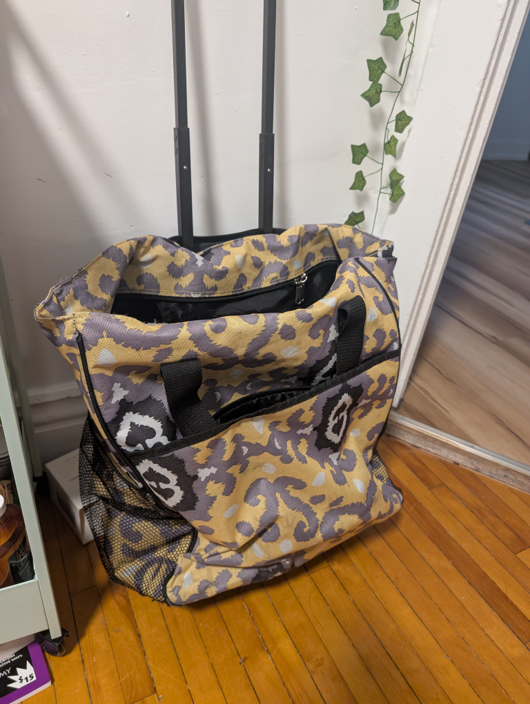 Yellow rolling suitcase about carryon size