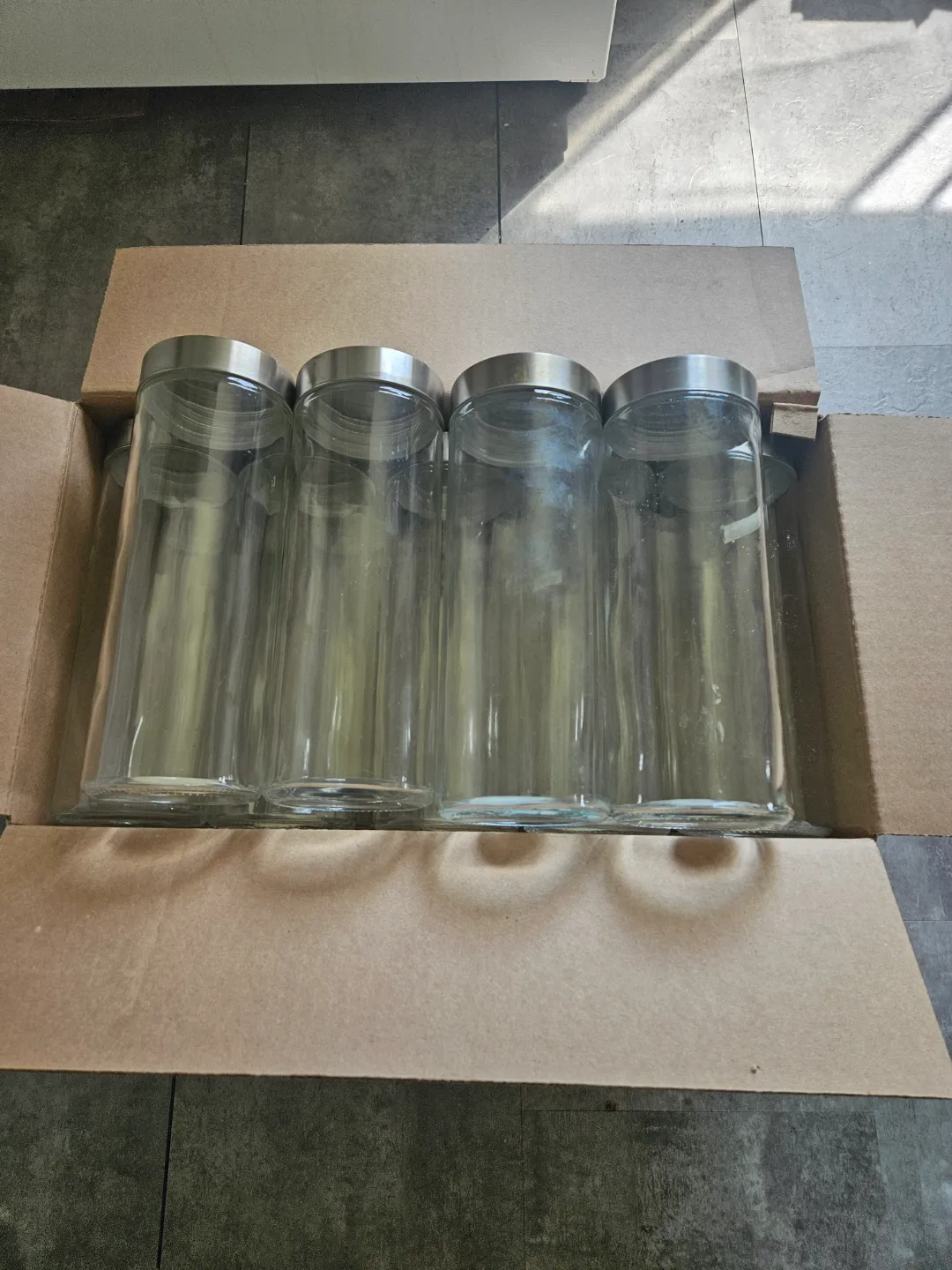 Set of four glass canisters with silver lids thumbnail