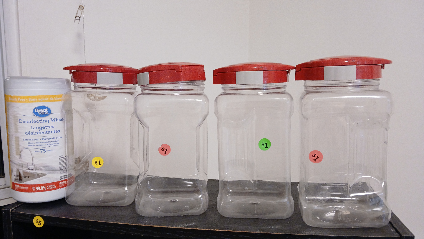 Four Clear Plastic Jars with Red Lids