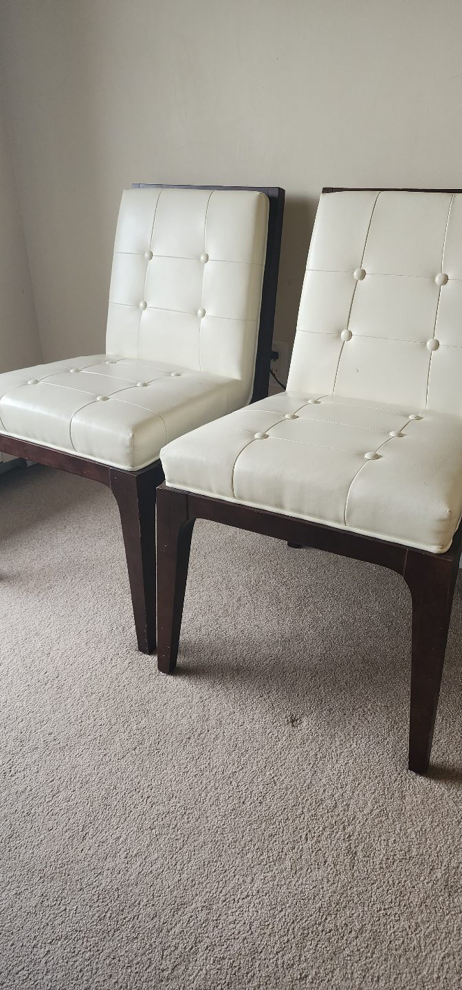 Pair of off-white button-tufted chairs