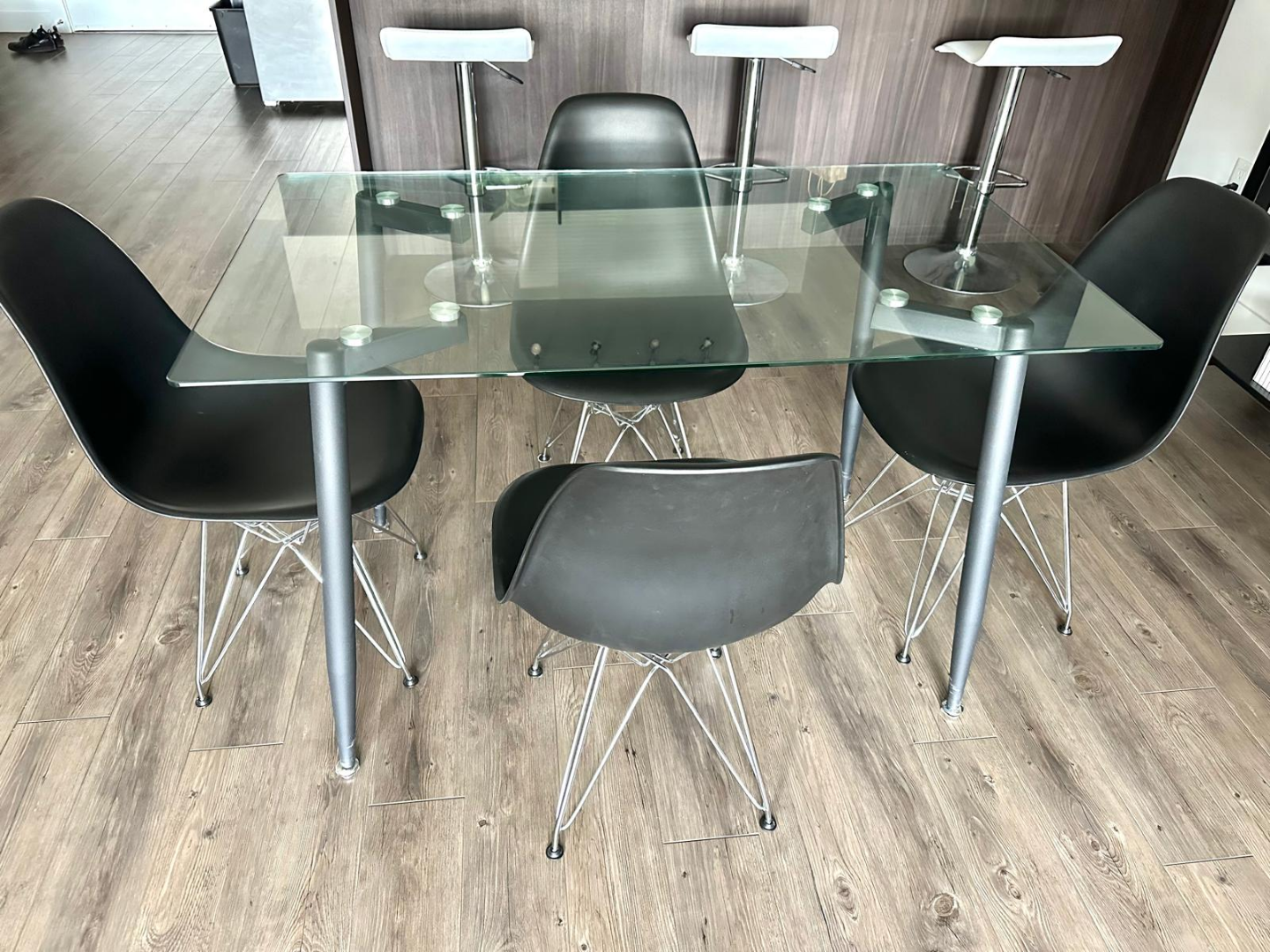 Glass-top dining table set with 4 black chairs
