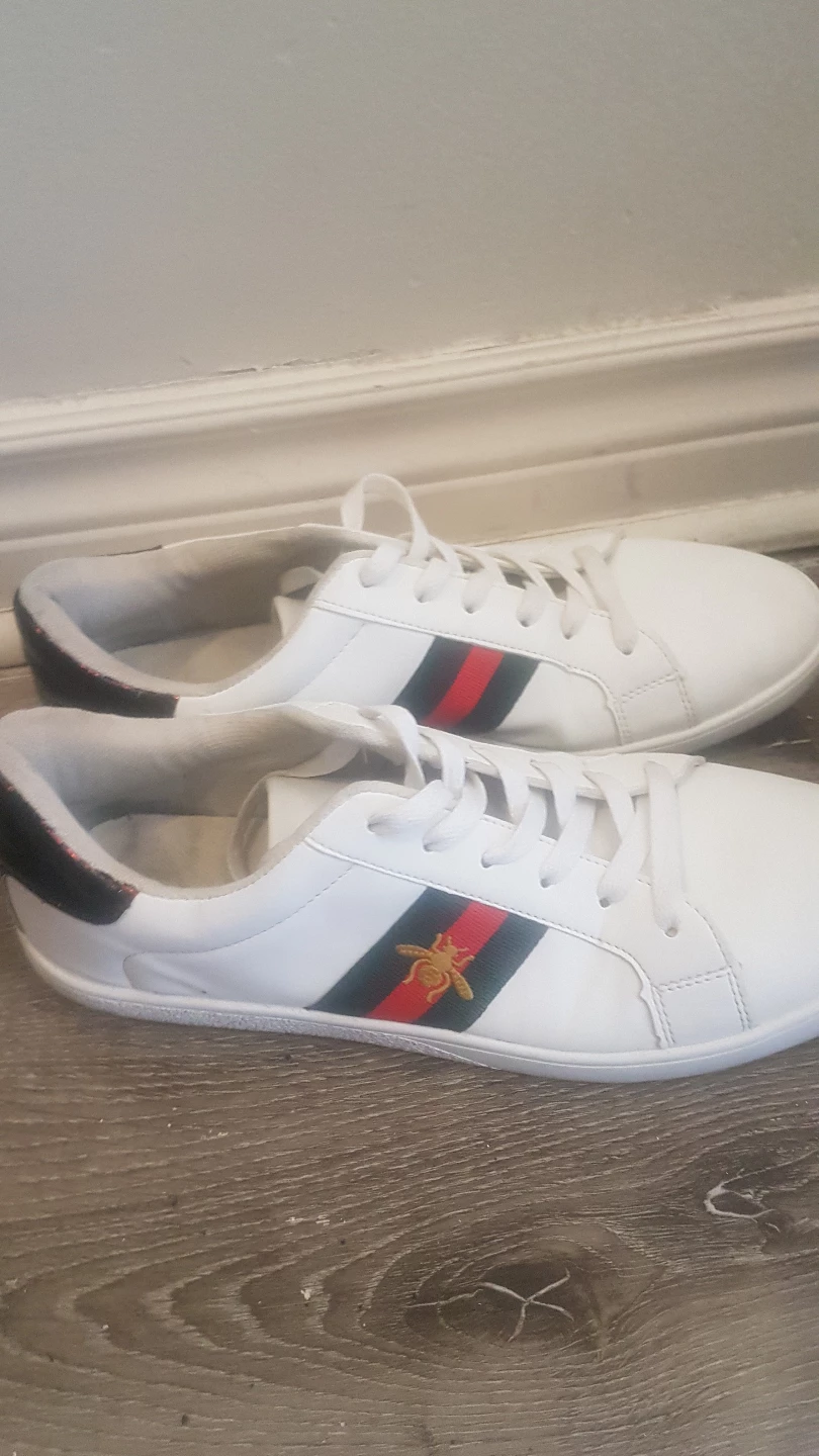 White leather sneakers with red and green stripes