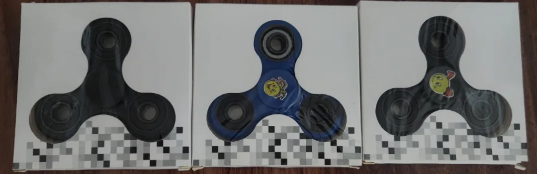 Three fidget spinners in original packaging thumbnail