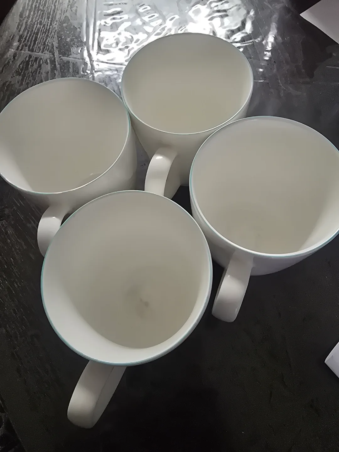 Set of four white porcelain mugs thumbnail