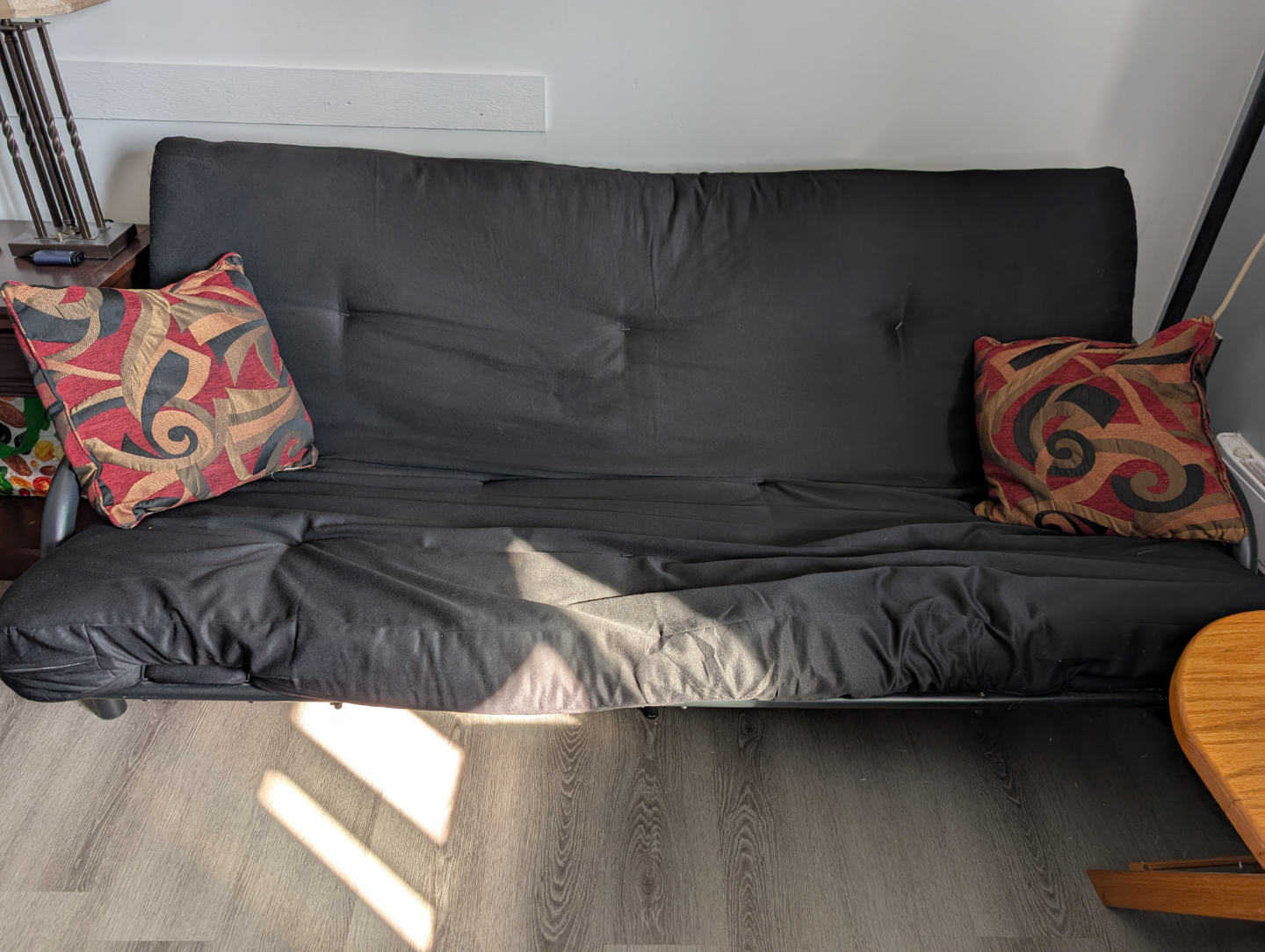 Black Futon with Two Throw Pillows