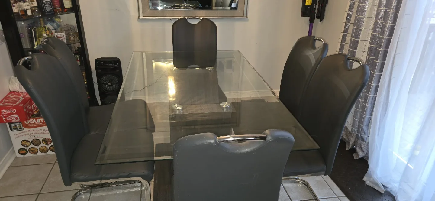 Glass top dining table with six gray chairs thumbnail