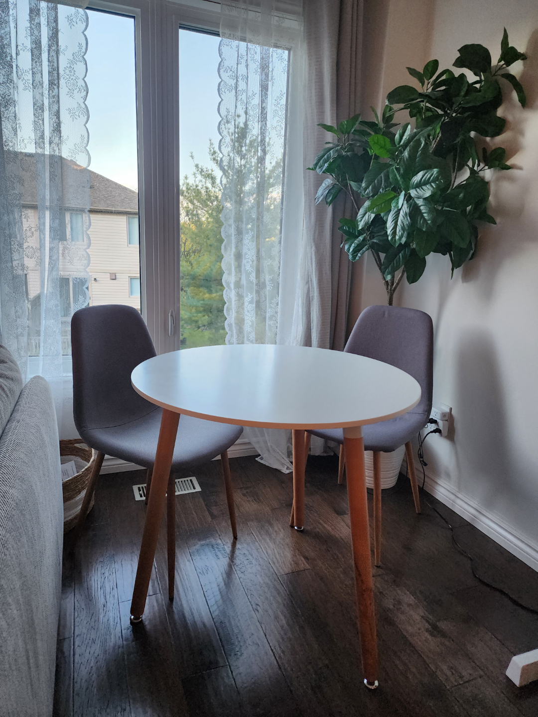 Round White Table and Two Grey Chairs