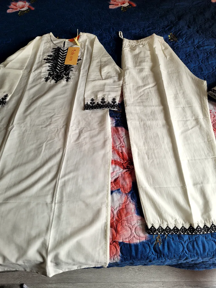 White two-piece outfit with black detailing image indicator(4)