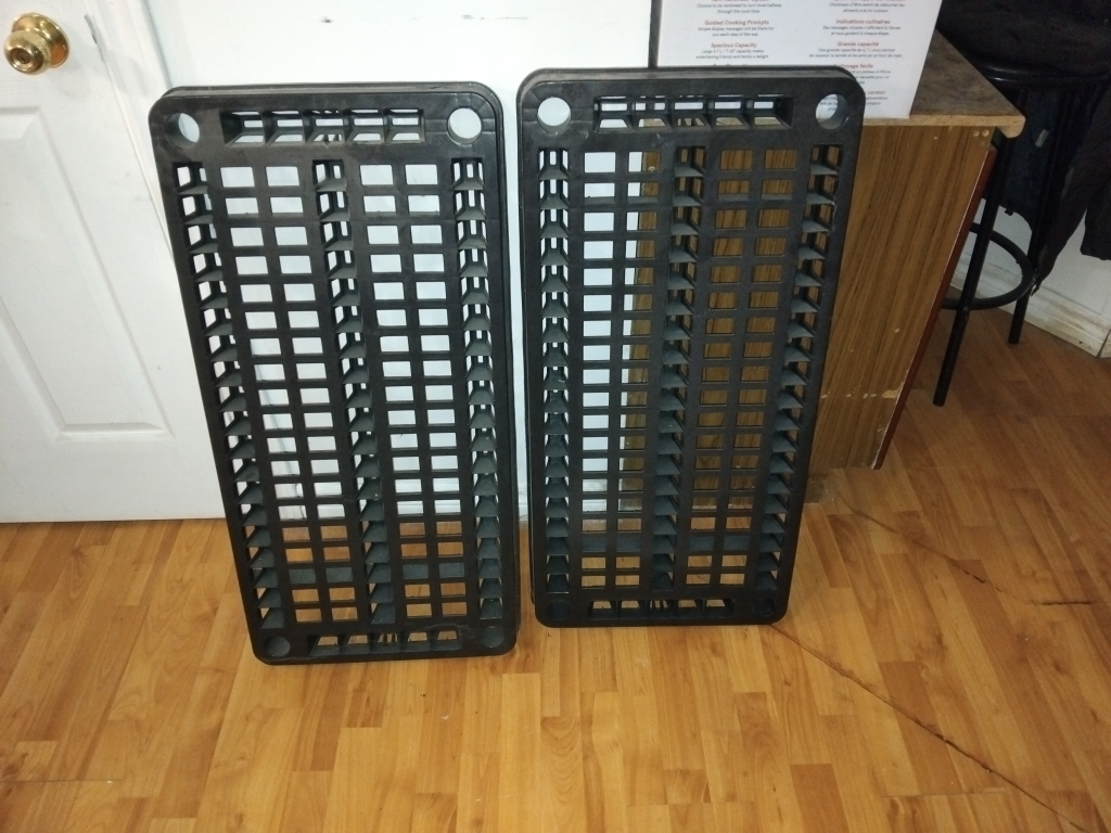 Two Black plastic shelves