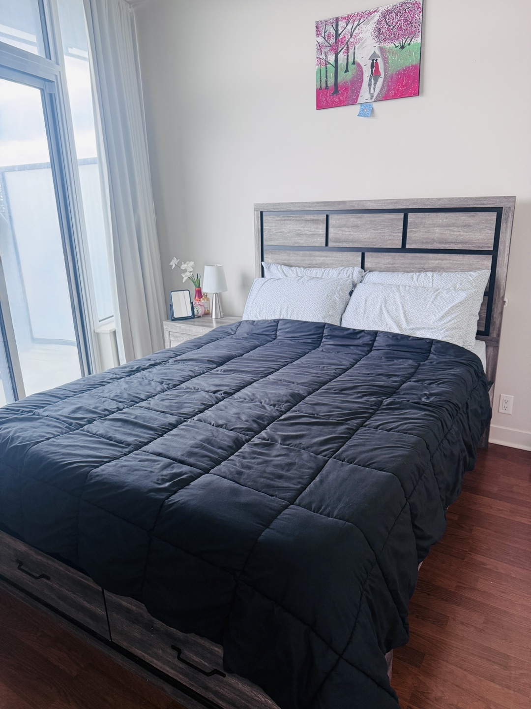 Queen size bed with storage, mattress, side table and bed lamp.