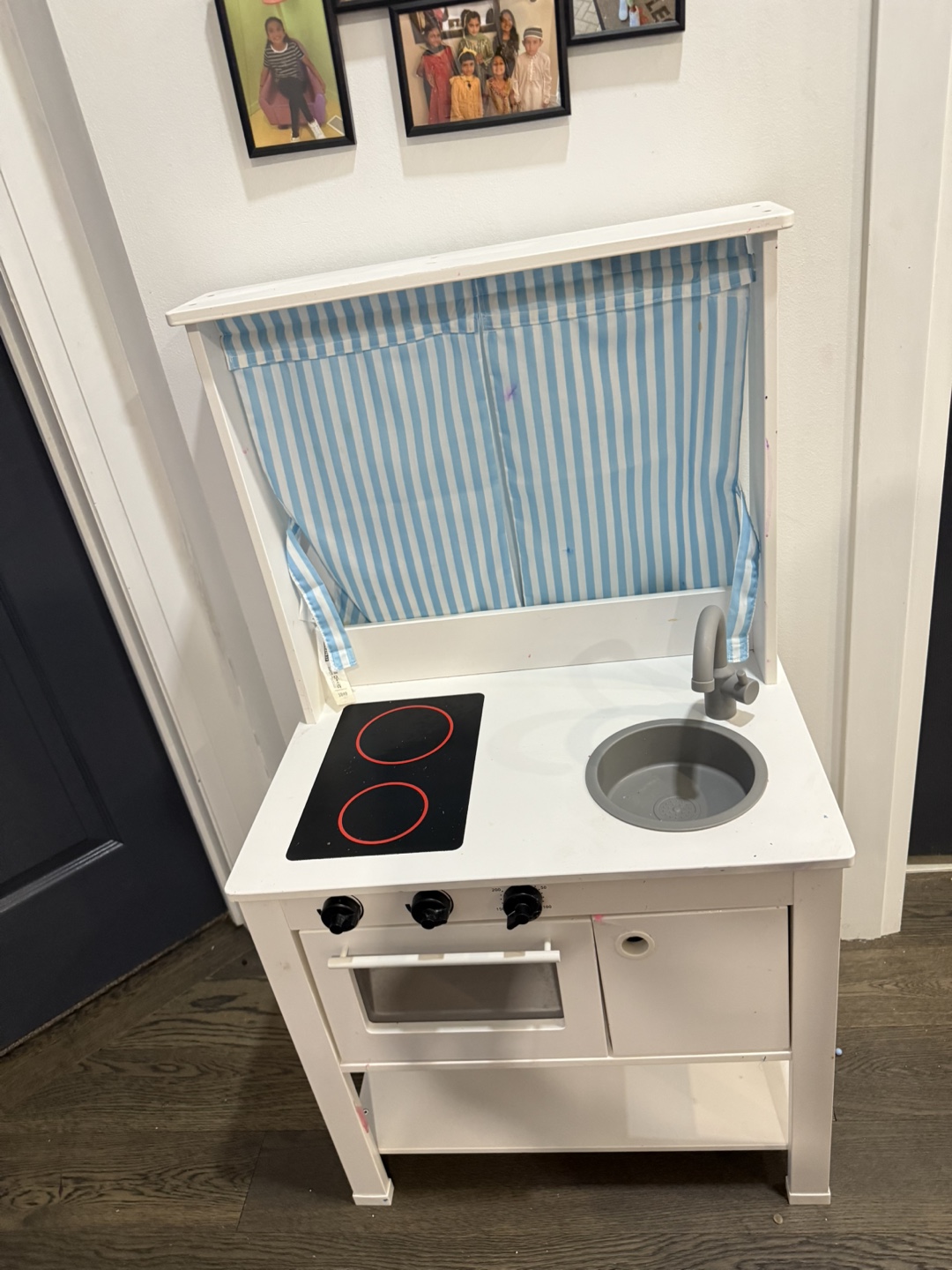 Wooden play kitchen with curtain