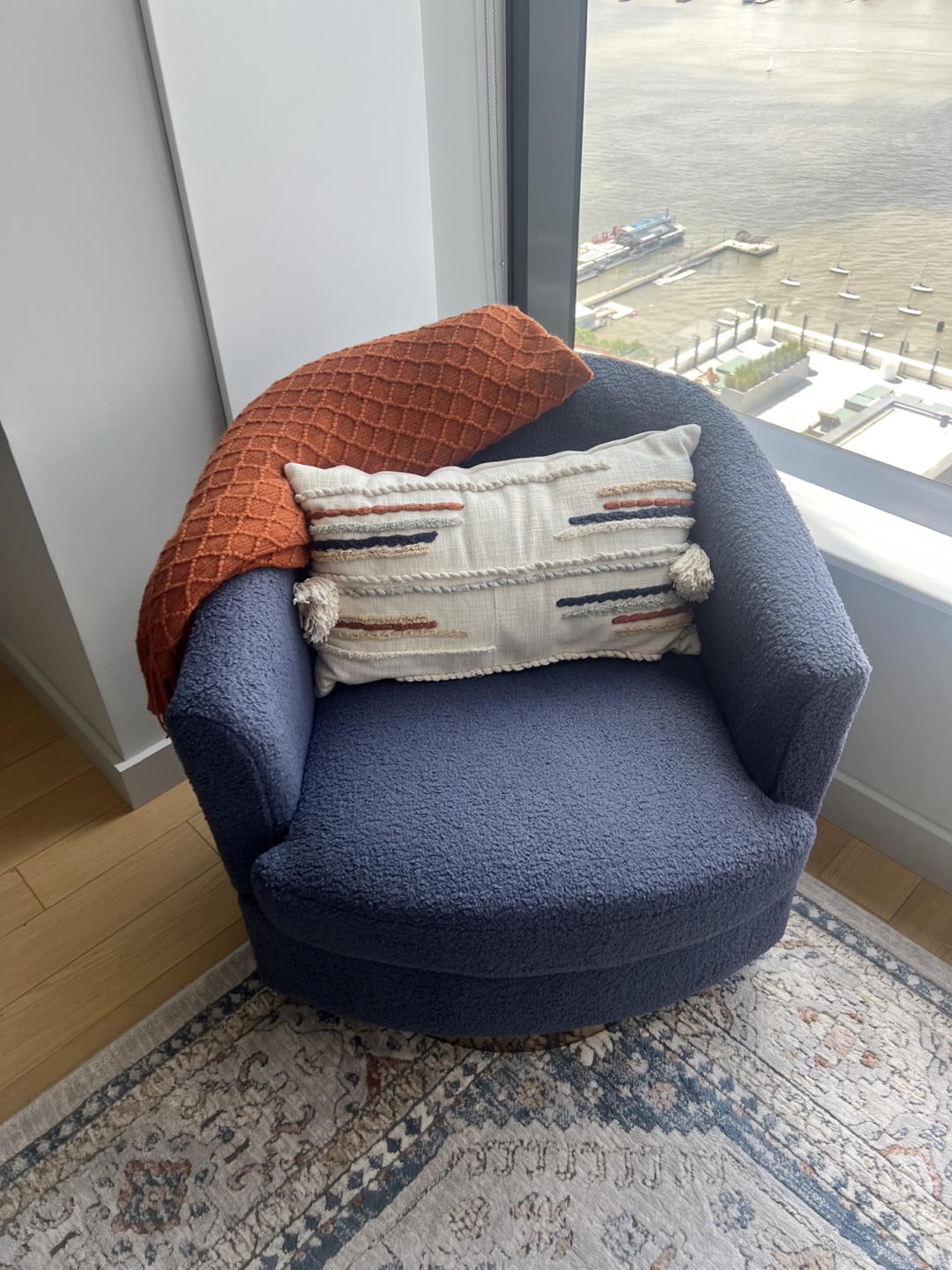 Cozy Blue Swivel Chair with Throw Pillow and Blanket