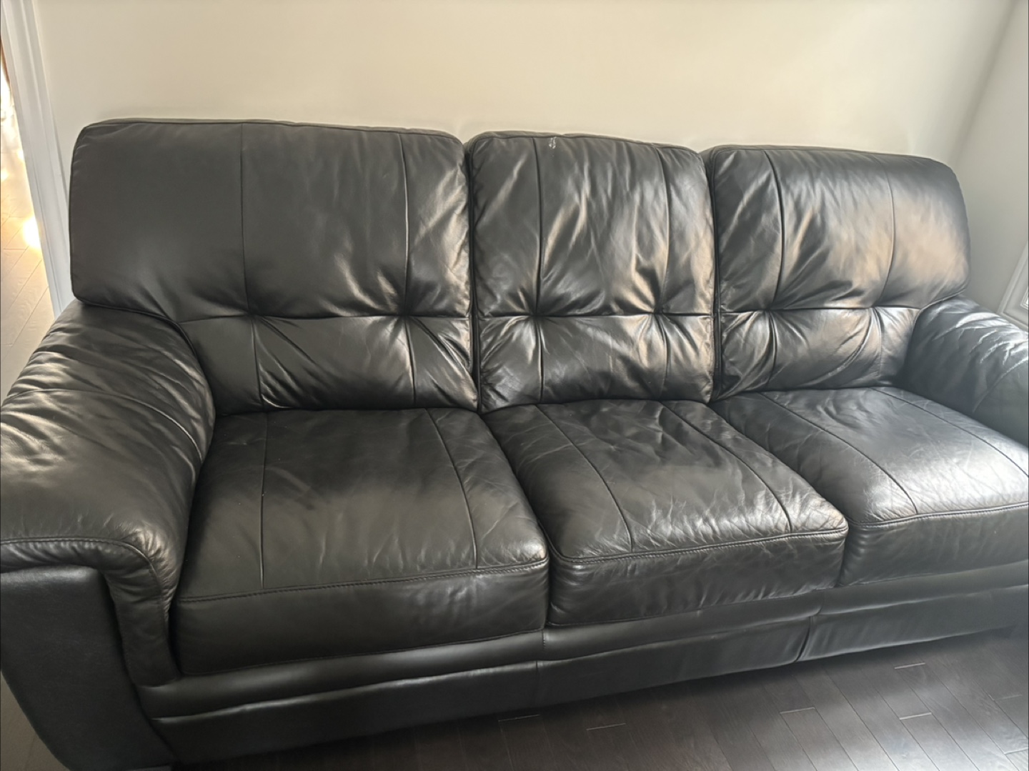 Black Leather Couch and Loveseat and one additional single seat.