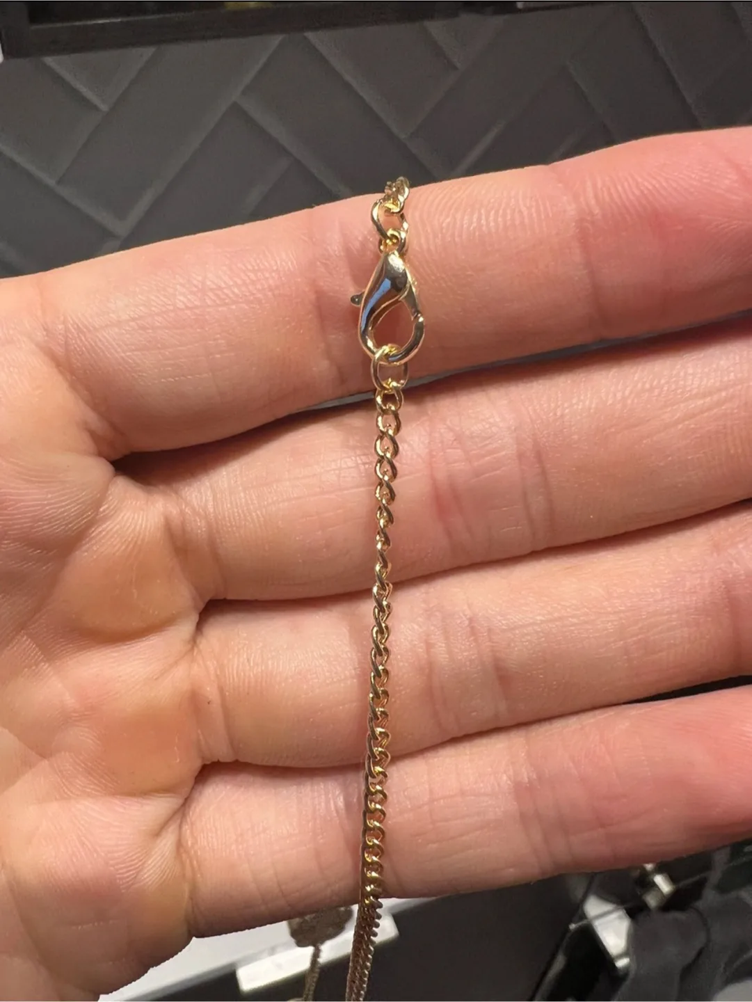 Gold-toned necklace with clover charms image indicator(4)