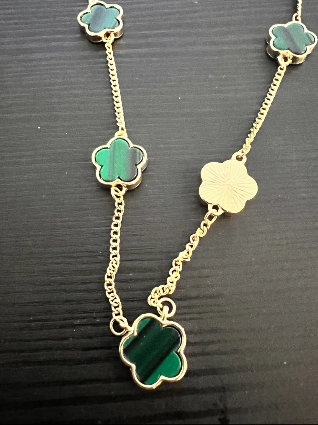 Gold-toned necklace with clover charms image indicator(2)