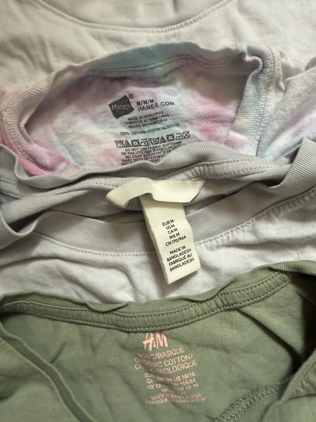 A12. Bunch of tops and t-shirts. Some are branded. image indicator(5)