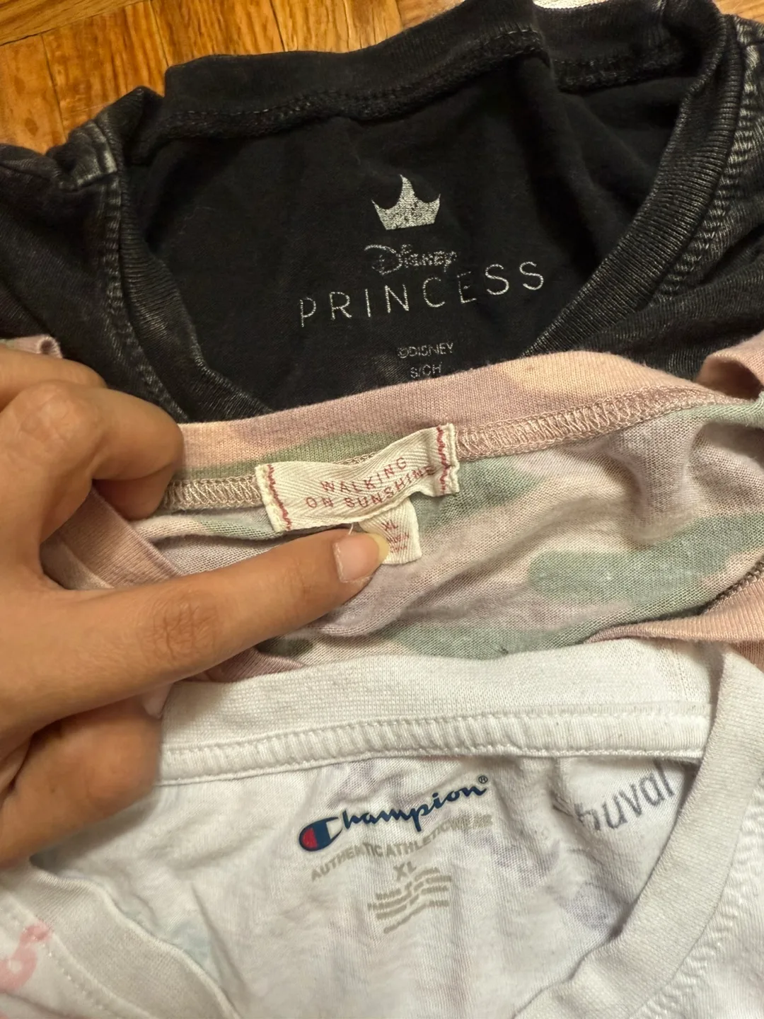 A12. Bunch of tops and t-shirts. Some are branded. image indicator(2)