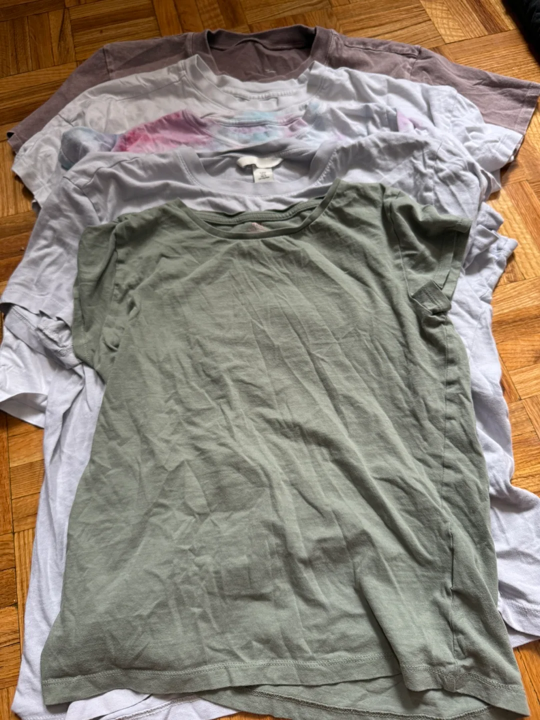 A12. Bunch of tops and t-shirts. Some are branded. image indicator(4)